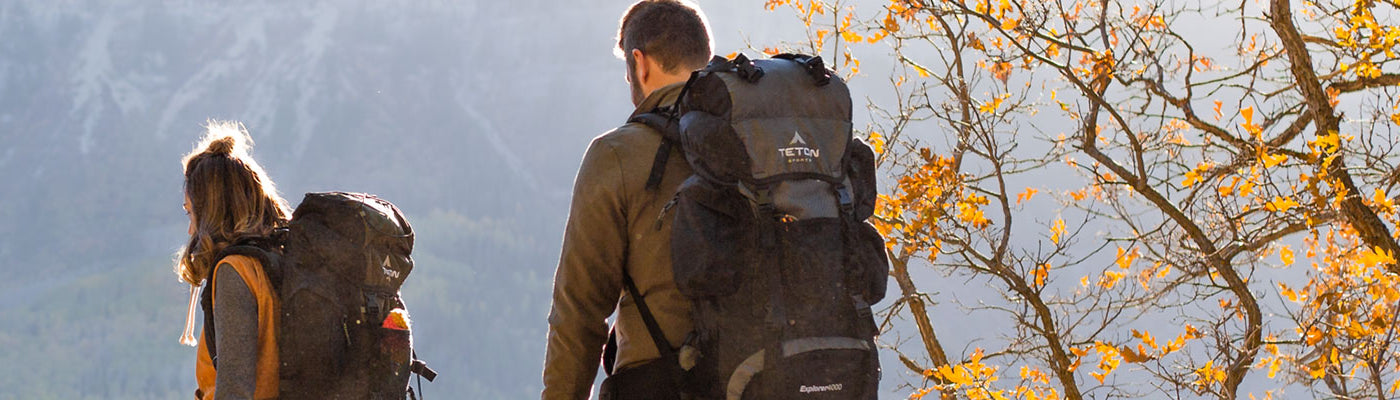 A man and woman with hiking backpacks