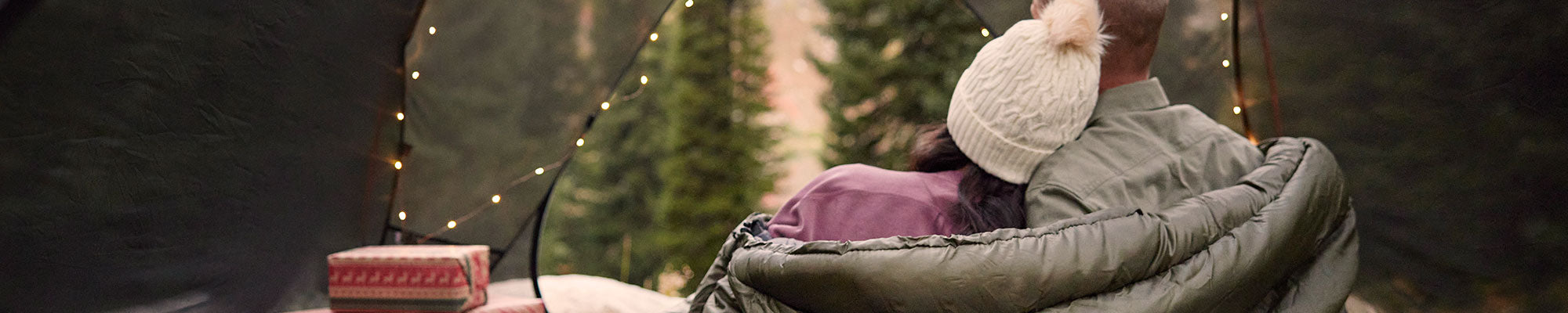 A man and a woman snuggle in their TETON Sports Mammoth double sleeping bag.