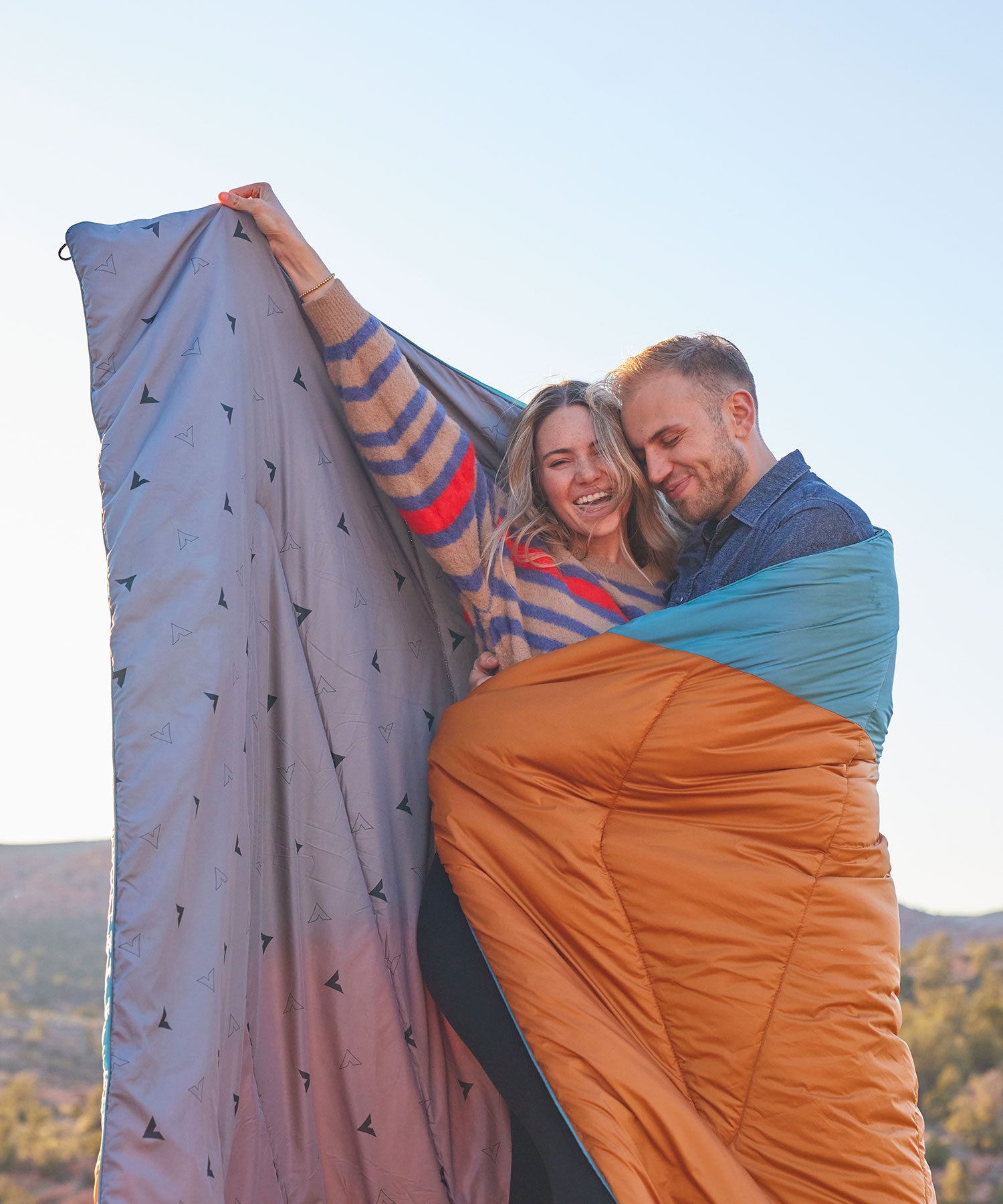 A couple snuggled in their TETON Sports Acadia Mammoth camp blanket.
