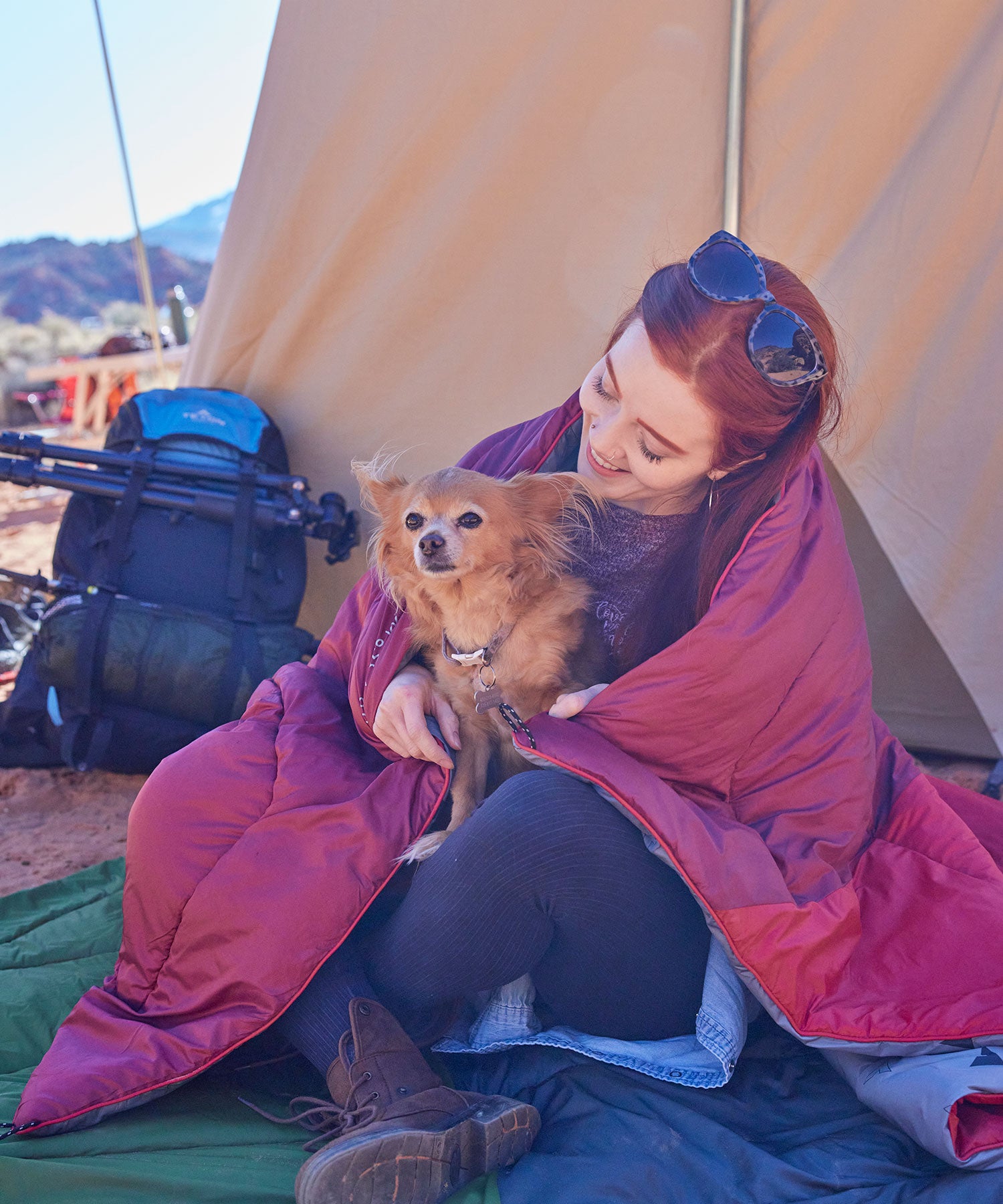 A woman and her dog snuggled up in a TETON Sports blanket.