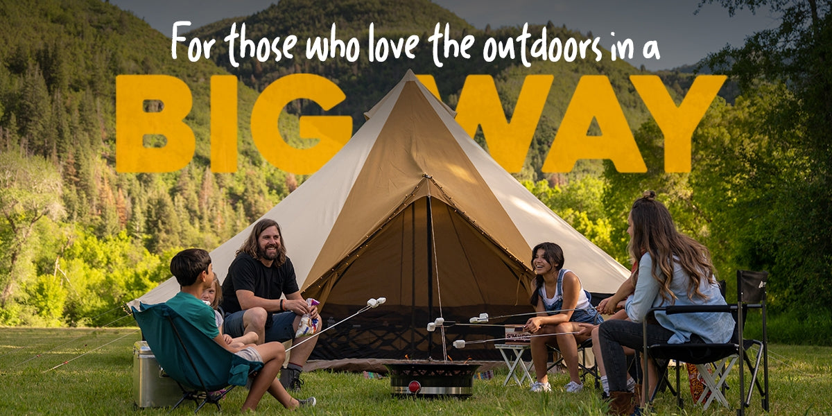 TETON Canvas Tents: Image shows a family of five camping together and roasting marshmallows. In the background is a TETON Sports Sierra bell-shaped canvas tent.