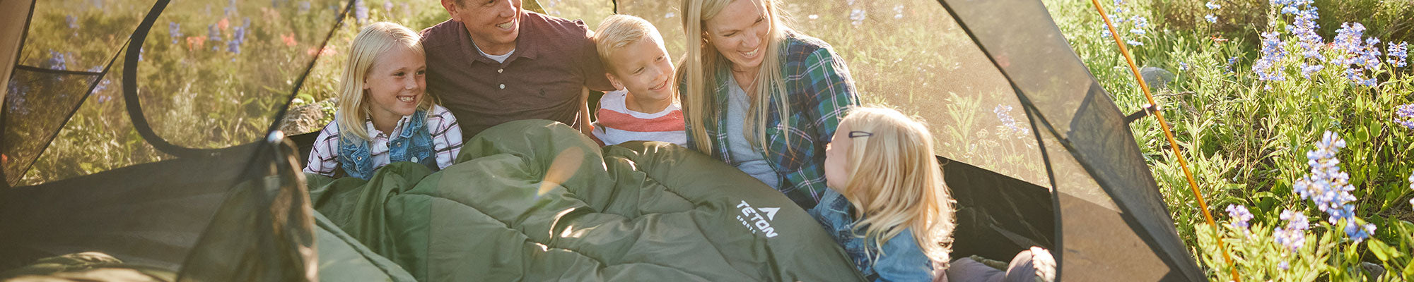 A family snuggles together in their Celsius Mammoth sleeping bag.