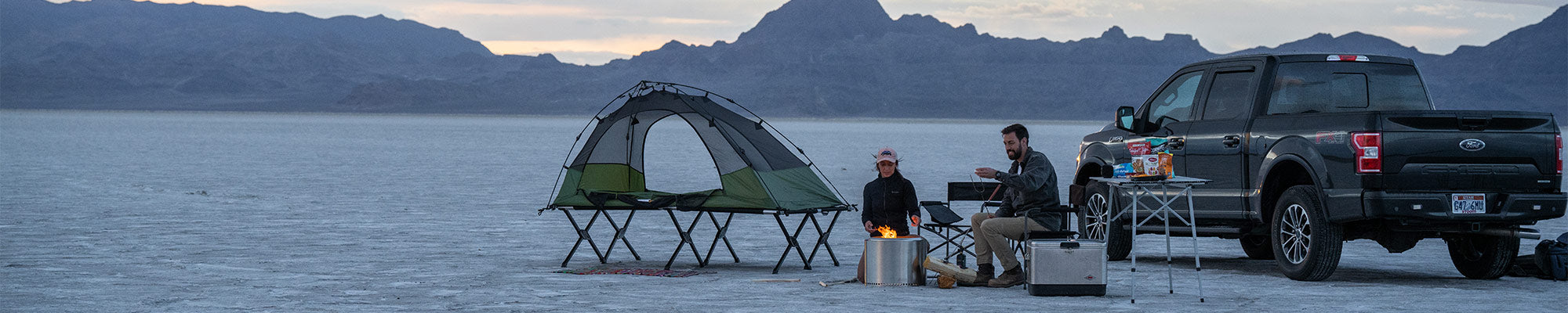 A couple camps on the Utah salt flats with their TETON Sports Vista Tent Bundle.
