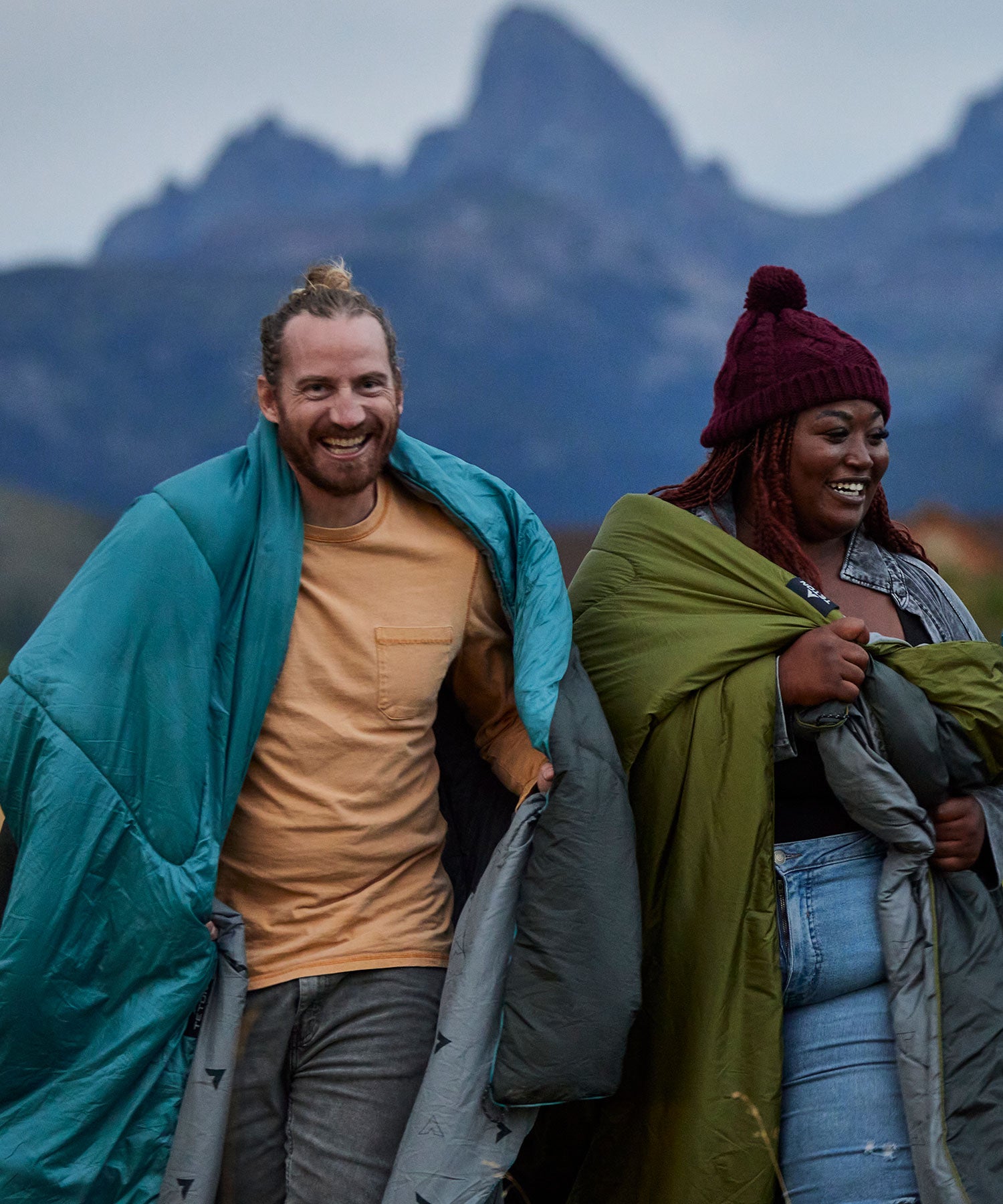 Two friends walking while wrapped in their TETON Sports outdoor camp blankets.